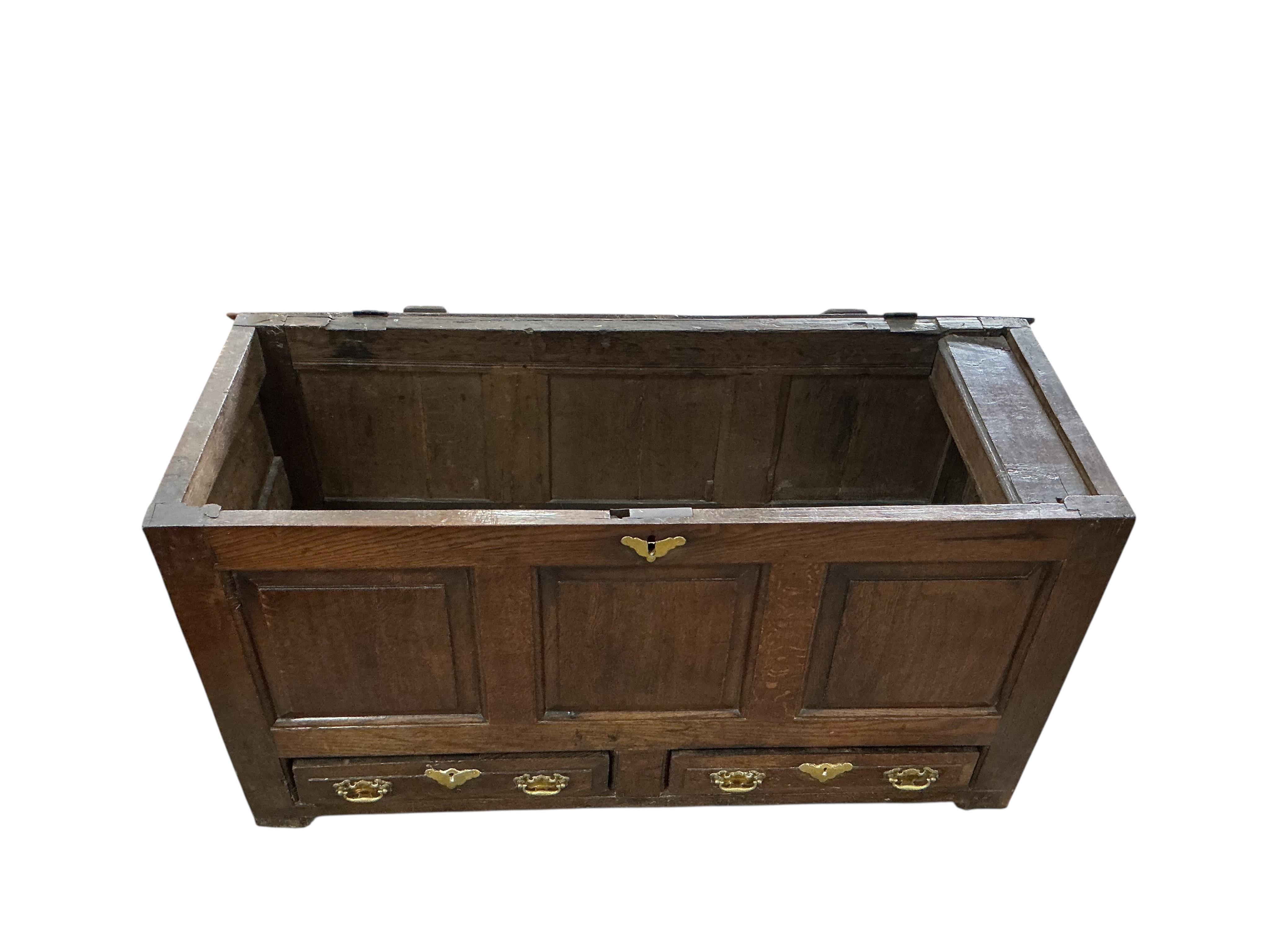 An early 18th century panelled oak mule chest, width 126cm, depth 48cm, height 68cm